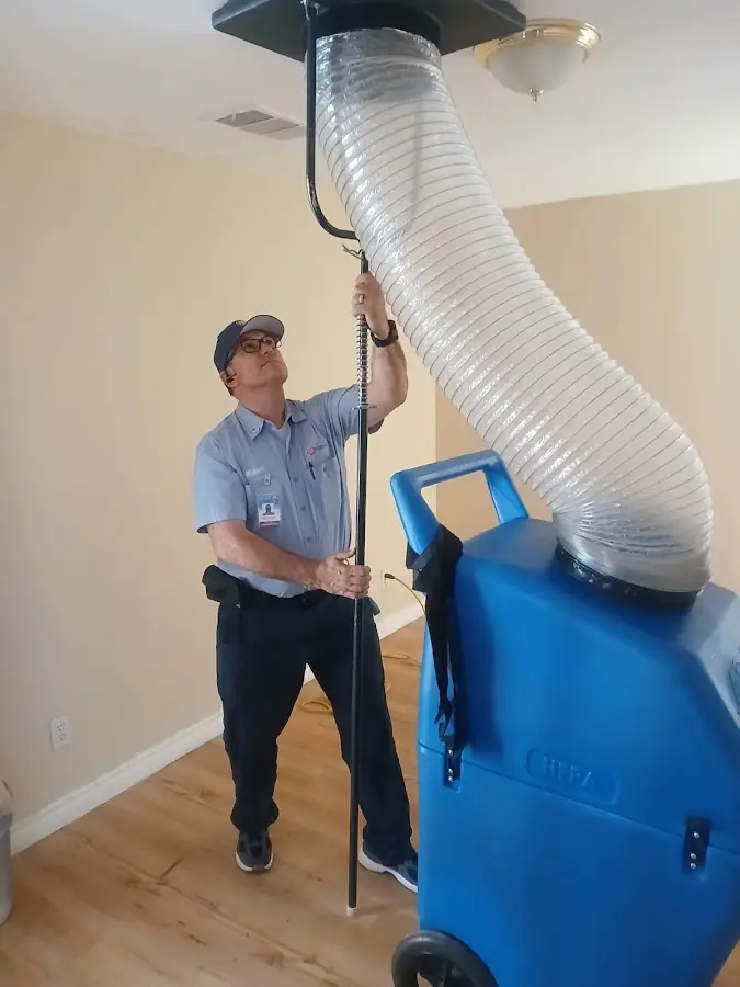 Furnace Tune-Up technician using HEPA equipment in Plant City