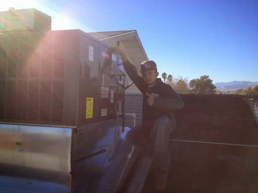 HVAC technician performing AC Tune-Up on a rooftop unit in Plant City